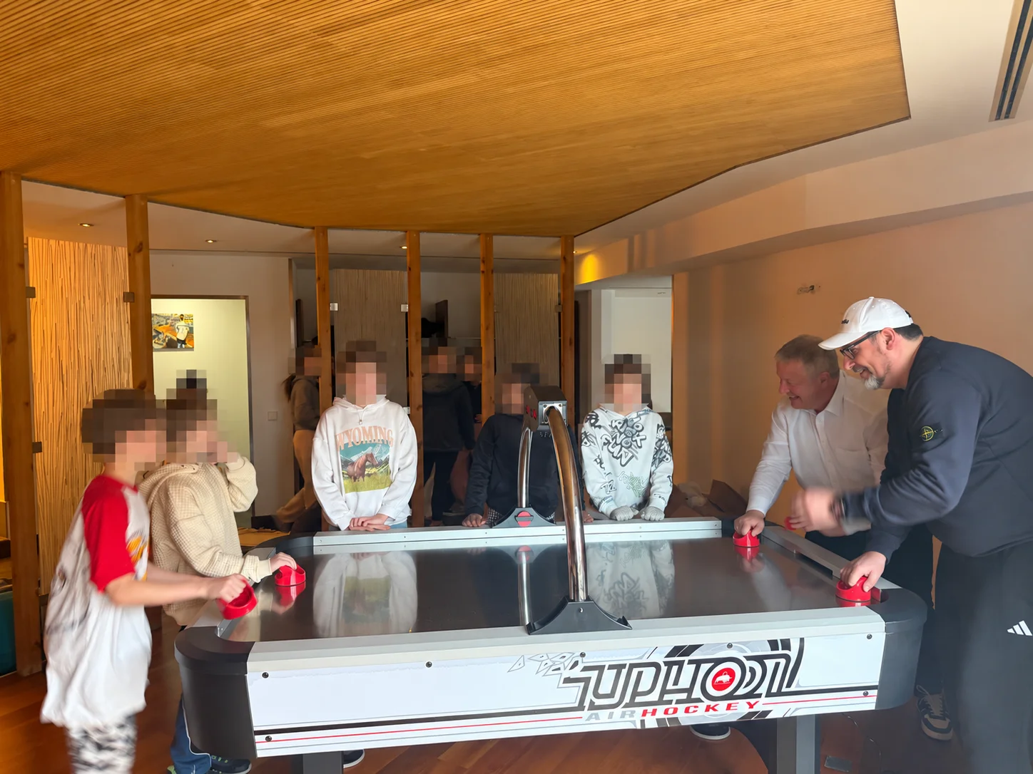 Playing air hockey together at the Kuppenheim youth centre; the children’s faces have been obscured